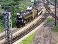 The ever popular (at the time) CN 6060 is seen returning to Toronto from the excursion to Niagara Falls. This view from the hillside at Hamilton Jct I understand is doable once again due to the leveling of the foliage by construction crews this past year. The train ran to the Falls and back twice weekly in summer, Wed and Sat., although in its last years it was often substituted with diesels due to various mechanical issues. On this day I elected to walk over to Ham Jct from Bayview for an angle that was different, for a change. Conditions at Bayview often became rather chaotic on account people visiting the Botanical Gardens adjacent would saunter down the hill to get a closeup view of the train's passing.