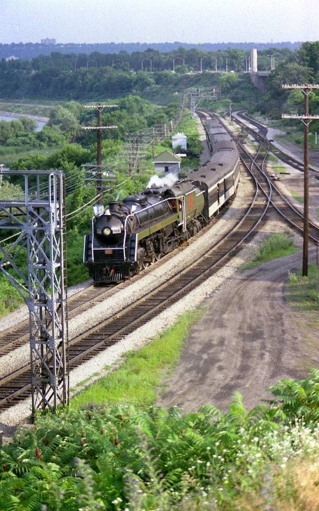 The ever popular (at the time) CN 6060 is seen returning to Toronto from the excursion to Niagara Falls. This view from the hillside at Hamilton Jct I understand is doable once again due to the leveling of the foliage by construction crews this past year. The train ran to the Falls and back twice weekly in summer, Wed and Sat., although in its last years it was often substituted with diesels due to various mechanical issues. On this day I elected to walk over to Ham Jct from Bayview for an angle that was different, for a change. Conditions at Bayview often became rather chaotic on account people visiting the Botanical Gardens adjacent would saunter down the hill to get a closeup view of the train's passing.