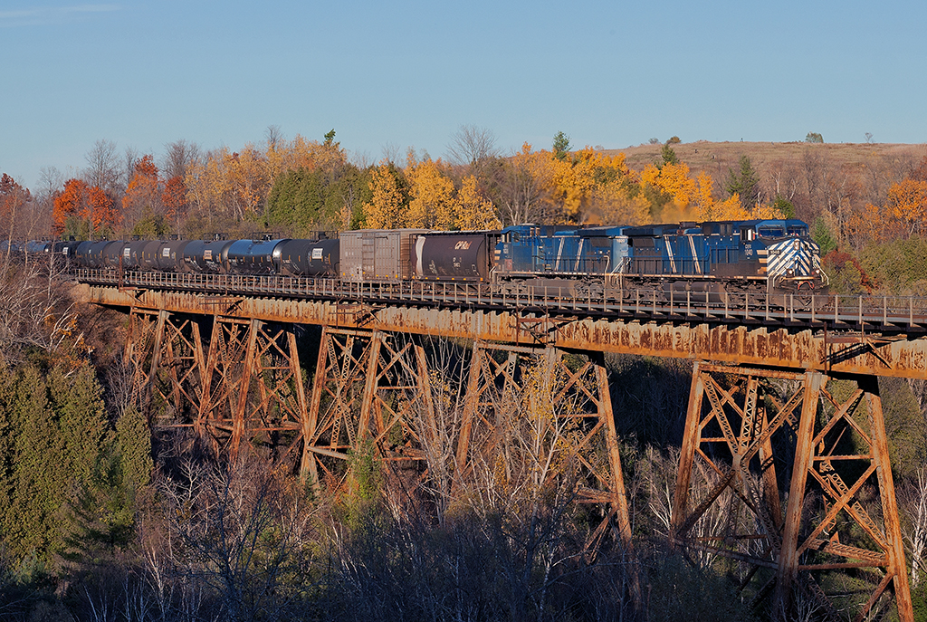Two bluebirds add a splash of colour to the autumn landscape as they lead an empty ethanol train west through Cherrywood. The train has made very good time since it departed Montreal this morning at 08:12 and only passed through here at 15:50 for Toronto.