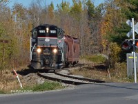 BCRY 1001 hauls its 4 car train across Huronia Rd in Barrie ON as 2 of the cars will be set off at a local industry in Innisfil and two will return and be set off to a local industry just North of the crossing at Huronia Rd (Crossing in photo)