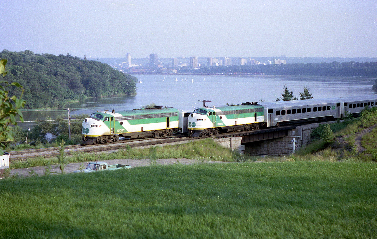 The race is on?  Not quite :o)  In this scene as shot from the hillside at the Botanical Gardens overlooking Bayview Junction, eastbound GO 902 on the south track is stopped on signal awaiting Hamilton-bound GO 708 which is passing on the north, (after crossing over) with GO 904 on the east end of train. Back in the two track days of the Oakville sub thru these parts GO used the south track, and the north was left open for CN and VIA as necessary. Not always was the window of opportunity available for a meet at this particular location though. Just luck and some good sunshine. Both of these former FP7 locos have been off the GO roster more than 20 years.