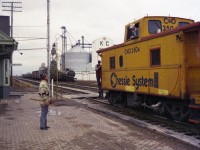 Forty years ago yesterday as of this posting there were still mainline freights passing thru Blenheim, Ontario. I know from my notes that this long freight had C&0 3044, 3568, 3046, 5753 and 5708 up front for power eastbound, but this is before the days I had a programmable scanner. Available to me only was the old under-dash Patrolman, which involved individual crystals at $5.95 a pop from some outfit in Oakville, and I did not have the money back then to buy crystals for areas outside of the Hamilton/Burlington area. So, I did not get transmissions nor a train number. C&0 station agent talks to on-train employees as they slow down to set off some cars in this old time rather up-front and personal scene. The building in the background is K.C. Fertilizers Ltd. The image, scanned from a negative of some substandard film I bought back then, was shot using a Miranda Sensorex RE. A junker of a 35MM camera in my case...............