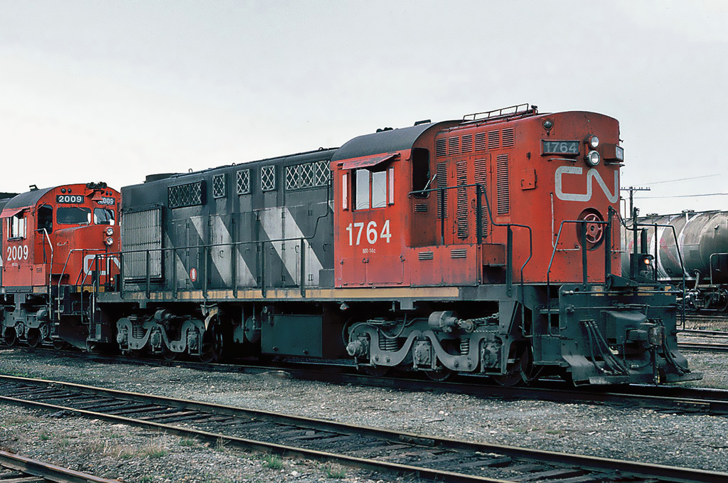 CN MLW RSC-14 1764 and MLW C-630M 2009 at the Bathurst yard May 03, 1987.