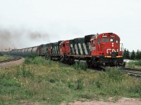  Halifax-Moncton mixed-freight with three MLW's C-630M 2009 & 2043 with M-636 2338, near CN's Gordon yard at Marsh Junction. August 20, 1985.