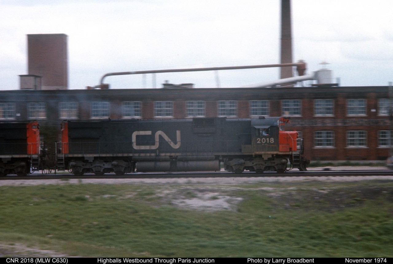 CN 2018 Highballs westbound through Paris Junction on a clear signal November 1974