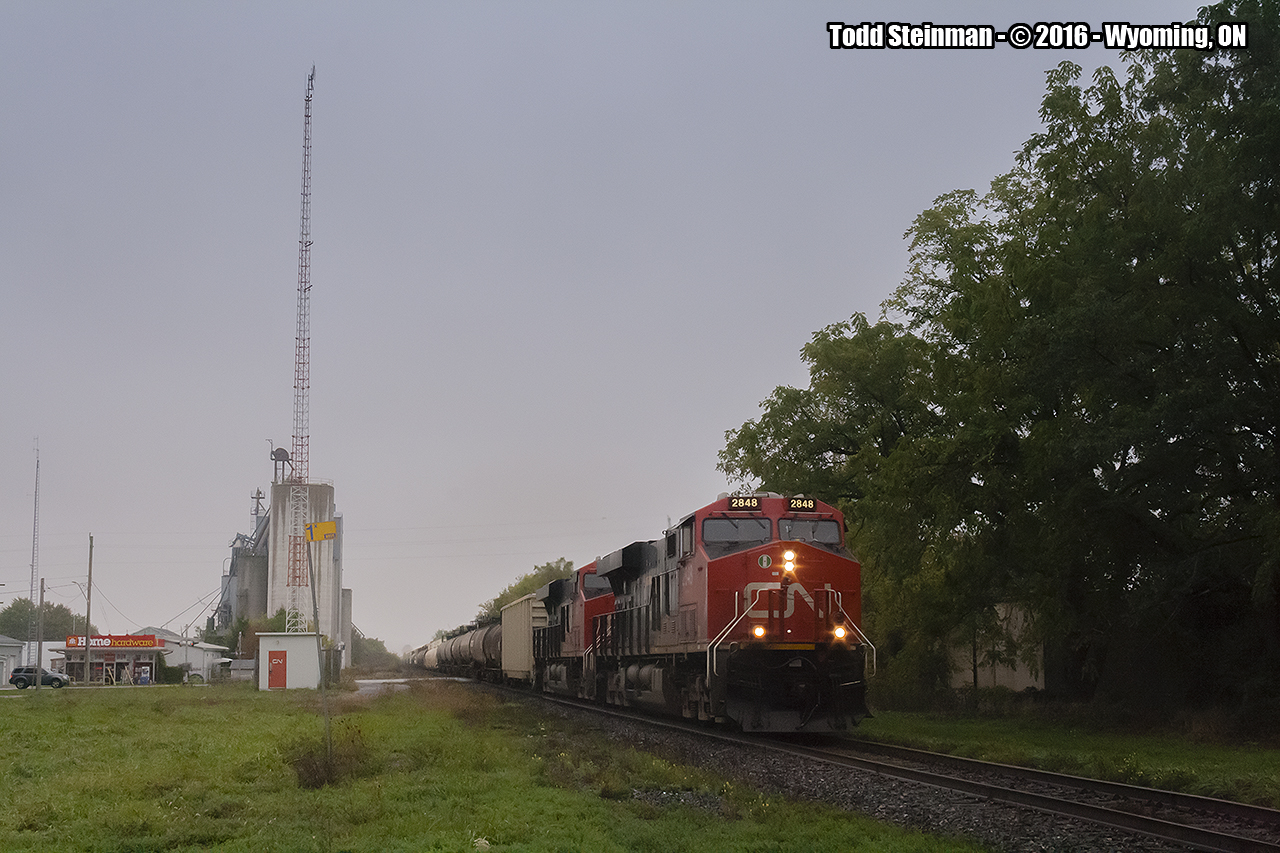 On an oddly, dreary yet drizzly cold October day, I was lucky enough to revisit one of my all time favourite spots for a little railfanning. My attempt - to Time Machine a photo by Arnold Mooney. Weather was not the only change of scene...gone were some trees, the station and maintenance shed, the platform. And of course, who could not notice that this stretch of the Strathroy Subdivision is now only down to a single track?


I did the best I could given the circumstances of the day. And all is not lost - the line seems to be as busy as it was when I was a 6 year old, living in nearby Petrolia...some 30 years ago, same with Arnold's photo. You can see his photo here:  http://www.railpictures.ca/?attachment_id=24979