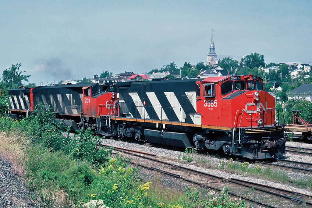 Eastbound CN Rail, with Bombardier units BBD HR412(W) 3585 and BBD HR616 2103 at Riviere-du-Loup, Québec August 10, 1992.
