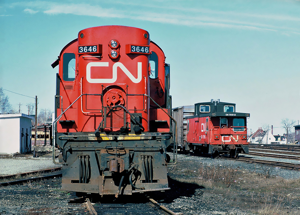 CN Rail MLW RS-18 No.3646 and CN caboose 79915 at Newcastle (now Miramichi), New Brunswick April 19, 1987.