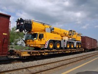 A huge Grove Crane on a westbound CN freight, slowly rolling through Bathurst, N.B. May 26, 2012