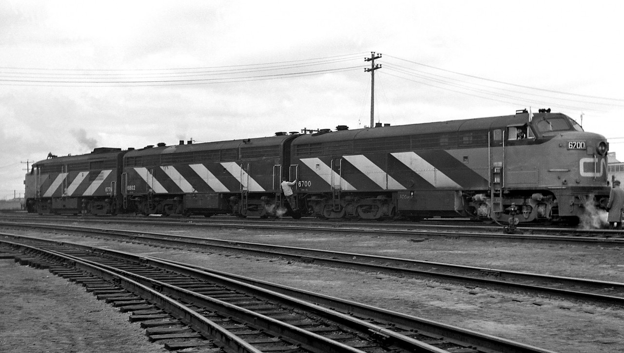 CN FM/CLC "C-Liners" CPA16-5 6700, CPB16-5 6802, and MLW FPA4 6776 sit in a matching zebra-striped A-B-A set, operating in freight service at Mimico Yard in 1969. Occasionally CN would press its dedicated passenger service GMD F-units, MLW FPA/FPB and FM/CLC C-Liners into mainline freight service. At this point in time the end was near for CN's fleet of FM/CLC units, many were already retired and being scrapped, and the final ones would retire later that year in 1969.

The Fairbanks Morse Consolidated Line or "C-Line" locomotive design was intended to be a flexible streamlined cowl unit platform a railroad could customize for freight or passenger service, with options for steam generators, fuel/water tanks, different opposed-piston engines with higher or lower horsepower ratings, dynamic or no dynamic brakes, etc. The C-Line wasn't particularly successful or a big seller, partially because by the time it was introduced railroads were beginning to move towards more conventional hood unit and road switcher designs, and partially due to reliability and maintenance issues with the units and their unique opposed-piston engines. FM exiting the locomotive market in the early 60's effectively turned them into oddballs on many railroads, and over their relatively short service lives many were re-engined, retired earlier than other builder's locomotives, or used as trade-in fodder for new locomotives.

Canadian production was licensed to the Canadian Locomotive Company in Kingston Ontario. In the early-mid 1950's CN purchased 26 A & B-unit freight C-liners in the 8700 series (later renumbered as 9300's), and 12 passenger C-liners with BB-A1A trucks and steam generators: CPA16-5's 6700-6705 and CPB16-5's 6800-6805, often used out of the Toronto area in passenger service with GMD and MLW passenger models. CN's fleet of FM/CLC units were retired in the mid-late 1960's and scrapped, but CP's fleet survived a few more years until retirement en masse in the mid-1970's.