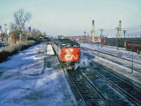 Bound for Toronto CN MLW FPA-4 6783 in charge of the late afternoon CN-CP pool train The International Limited, boarding passengers at Westmount Station March 11, 1965. We can see downtown Montréal in the distance.