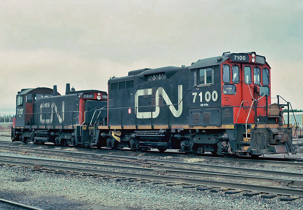 CN GMD/CN SW1200RM. Remanufactured at Pointe St. Charles main shops in Montreal; Nos.7100-7107 with SW1200SW and long hoods of GP9s.