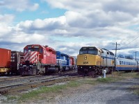 Toronto-Ottawa VIA train coming off the VIA Rail Brockville Sub., onto the CP Winchester Sub., at Smiths Falls, Ontario. Westbound CP Rail GMD SD40 5506 with its train waiting for a new crew.  October 25, 1996.