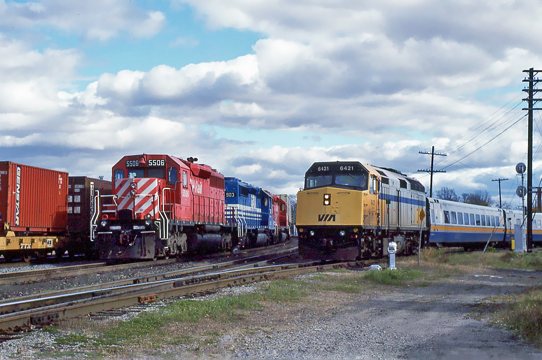 Toronto-Ottawa VIA train coming off the VIA Rail Brockville Sub., onto the CP Winchester Sub., at Smiths Falls, Ontario. Westbound CP Rail GMD SD40 5506 with its train waiting for a new crew.  October 25, 1996.