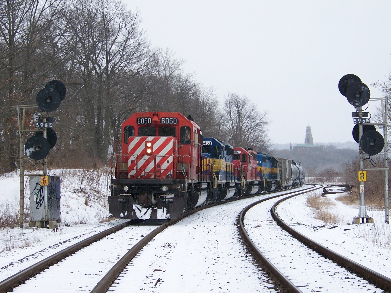 A few years ago we were seeing quite the number of ethanol trains running over the Hamilton Sub en route to the USA. Since the returning empties were not a priority train, parking them out of the way became a bit of a problem around Kinnear, so the solution was to leave them out of harm's way down by the Hamilton Cemetery curve just before the High Level bridge, out by Cootes Paradise. I think back with amusement about how so many of us would hear the clearance northward from Kinnear and then stake out a location to catch the train from Hambone to Guelph Jct, only to have it not show up........but rather 'hide' in the confines of the lower level area of the Cemetery. Maybe it wasn't THAT funny.....I was fooled a couple of times myself. Power on this 'hidden' train was CP 6050, ICE 6453, DME (CP paint) 6078 and DME 6360.