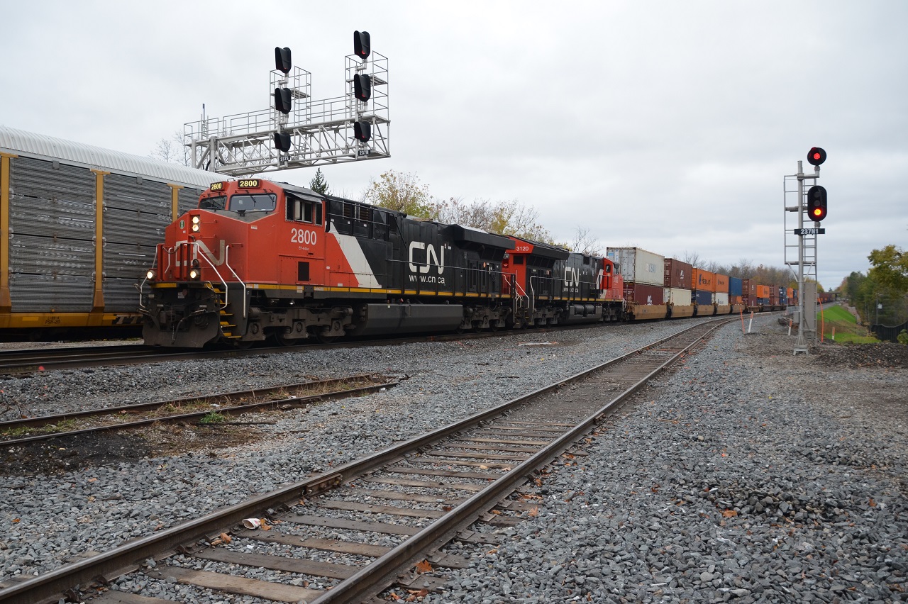 CN Q148 passes along side the new third track with the first gevo and the last gevo so far