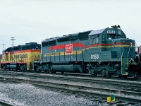  W/B CSX freight in CP's Montrose yard with Chessie System (B&O) GP38 No.3843 and Family Lines System (SBD) SD40-2 No.8153. October 22,1987.