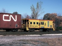 Chessie System C&O Caboose 904121 on a westbound CSX freight is leaving the CP yard after it stopped for a crew change. October 26, 1987