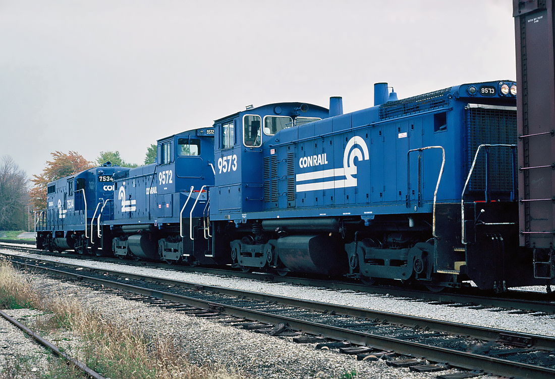Conrail EMD GP10 No.7534 a rebuilt GP9, with two EMD SW1500s  at Fort Erie, Ontario  October 21, 1986.