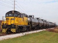 Essex Terminal GP9 #108 has 15 loads of whiskey bound for Diageo Distilleries in Amherstburg as the train is about to cross county road 10 just minutes before entering Amherstburg. The day started by collecting interchange cars then heading out to Ojibway yard with a 21 car train. After switching for a couple of hours in Ojibway alongside another yard job, 108 headed south with their 15 cars ready to switch Diageo. Once complete, the crew will head back North to Ojibway, switch local industry and build their train to take to CN and CP for interchange. 