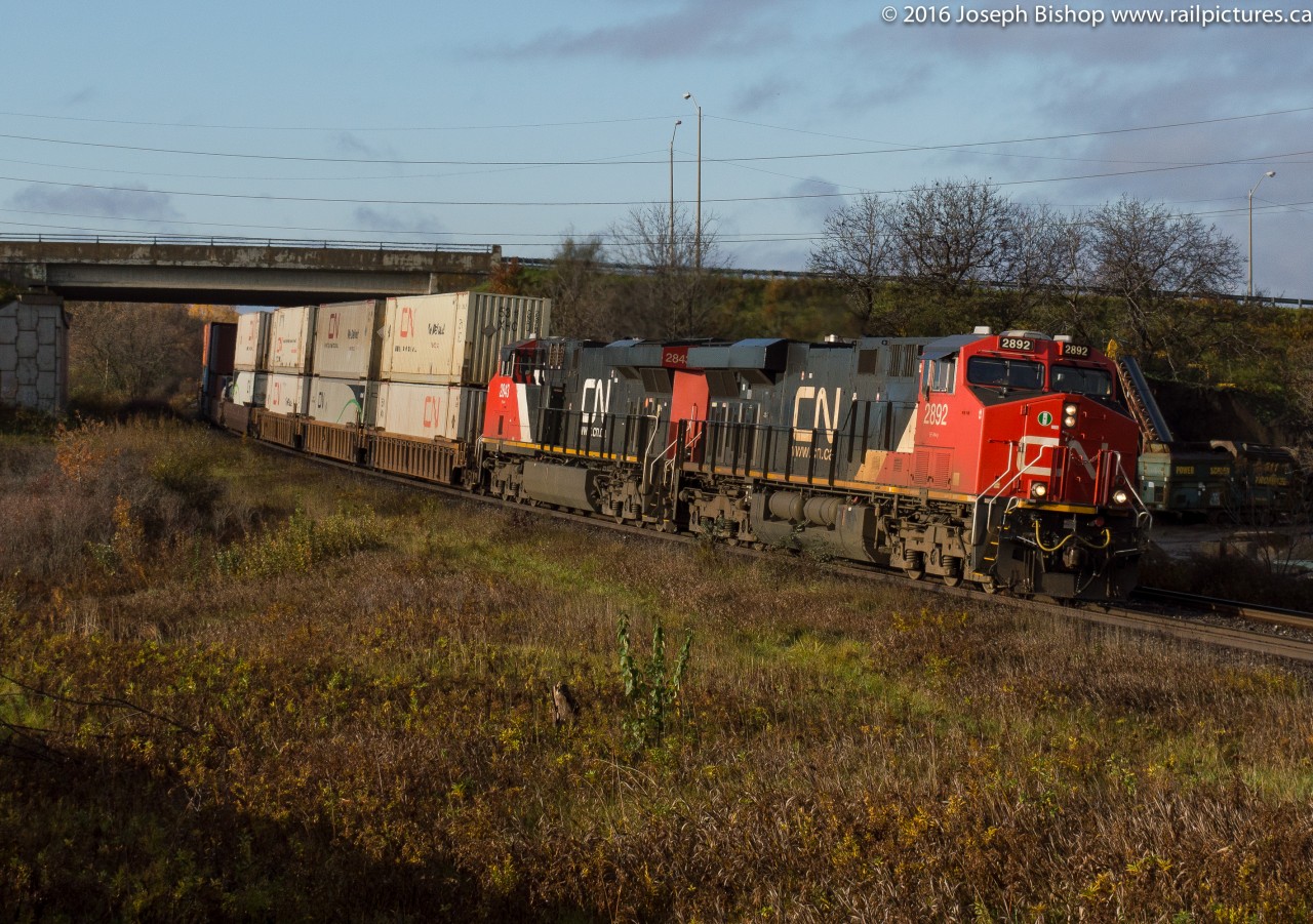 During a brief period of sun this morning CN Q148 curves out of Brantford at Garden Ave with a pair of ES44AC's