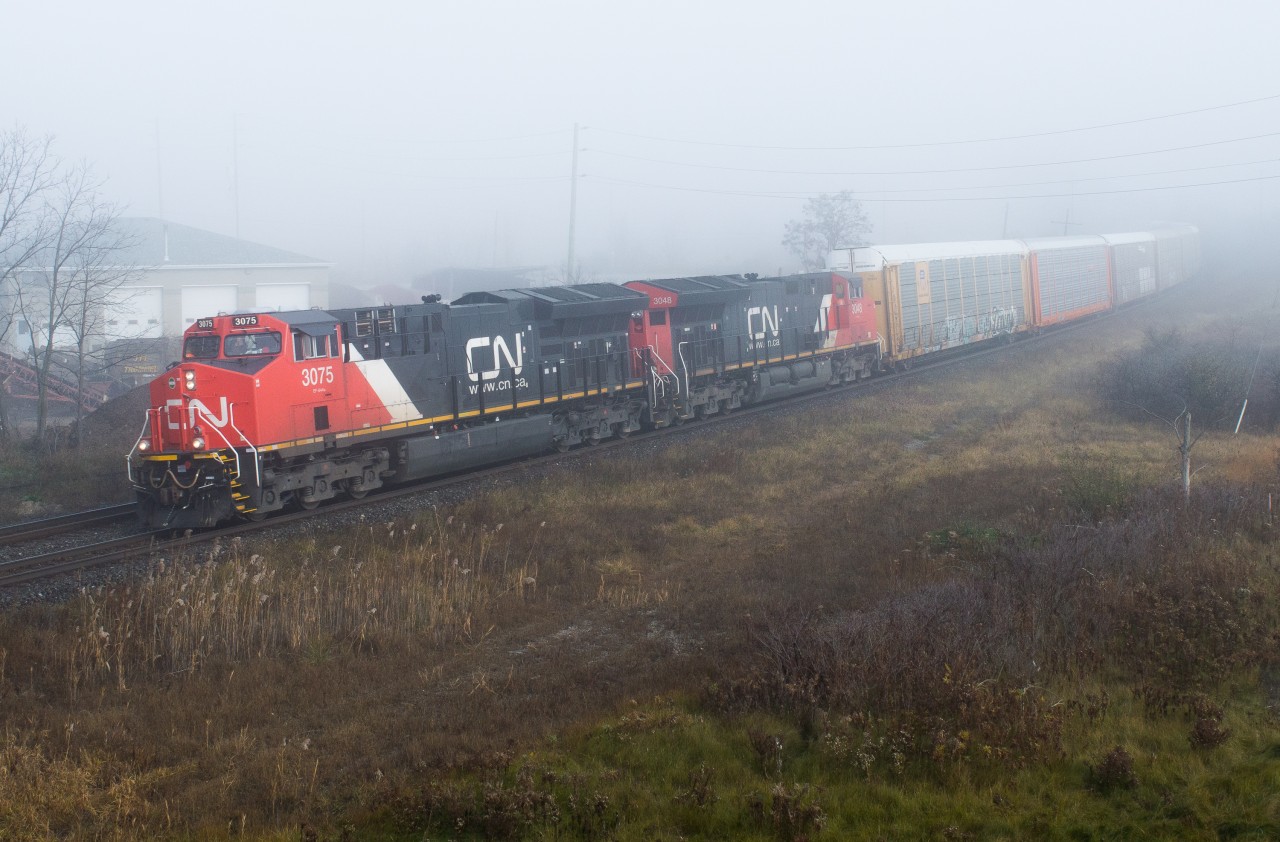 CN 371 emerges from the thick fog that blanketed much of Brant County on Thursday morning with a pair of Tier 4 GEVOs on the point.  The fog patterns were quite odd that morning, most of my drive to Brantford was sunny but upon hitting Highway 2 and Cainsville it was pea soup!