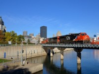 <b>An advantage of daylight savings time.</b> CN 149 is leaving the Port of Montreal on a gorgeous morning with ET44AC's CN 3015 & CN 3086 for power as it crosses the Lachine Canal. At right is the bulk carrier <i>Venture</i>, which has been in the port since the end of last year. This shot is only doable with a good sun angle for this train during the shorter days of daylight savings time.