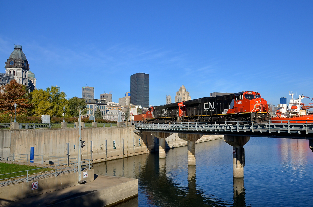 An advantage of daylight savings time. CN 149 is leaving the Port of Montreal on a gorgeous morning with ET44AC's CN 3015 & CN 3086 for power as it crosses the Lachine Canal. At right is the bulk carrier Venture, which has been in the port since the end of last year. This shot is only doable with a good sun angle for this train during the shorter days of daylight savings time.