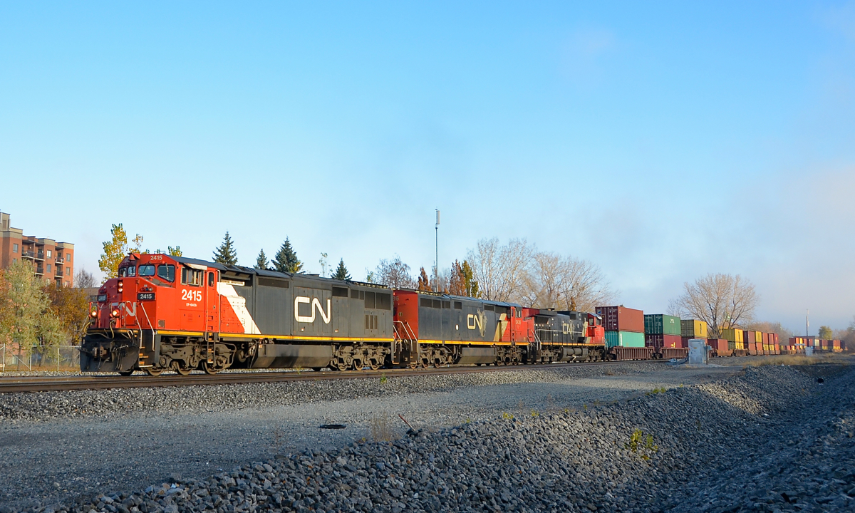 CN 149 is through the St-Henri neighbourhood of Montreal with Dash8-40CM's CN 2415 & CN 2436 and Dash9-44CWL CN 2503, all with Canadian cabs, on an on and off foggy/sunny morning.