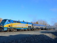VIA 906 leads 7 stainless steel cars as it leads VIA 63 through St-Henri.