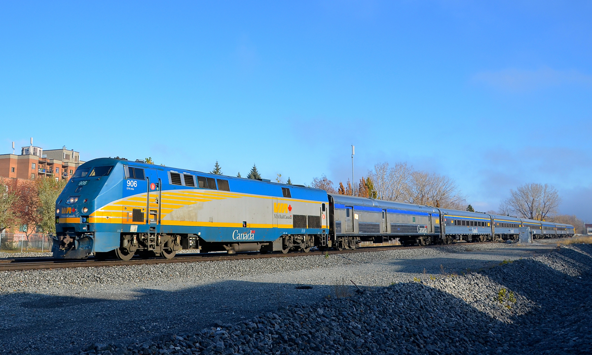 VIA 906 leads 7 stainless steel cars as it leads VIA 63 through St-Henri.