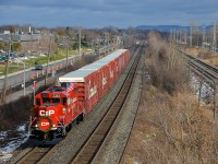 I got lucky twice over in catching the CP Holiday Train this afternoon, as I barely beat it to the St-Jean overpass in Pointe-Claire and I got a few minutes of sun during a mostly cloudy day. Here it is seen heading for shows in Ontario this afternoon, with CP 2323 leading a 62-car axle train. Up ahead are stops in Finch, Merrickville, Smiths Falls and Perth.