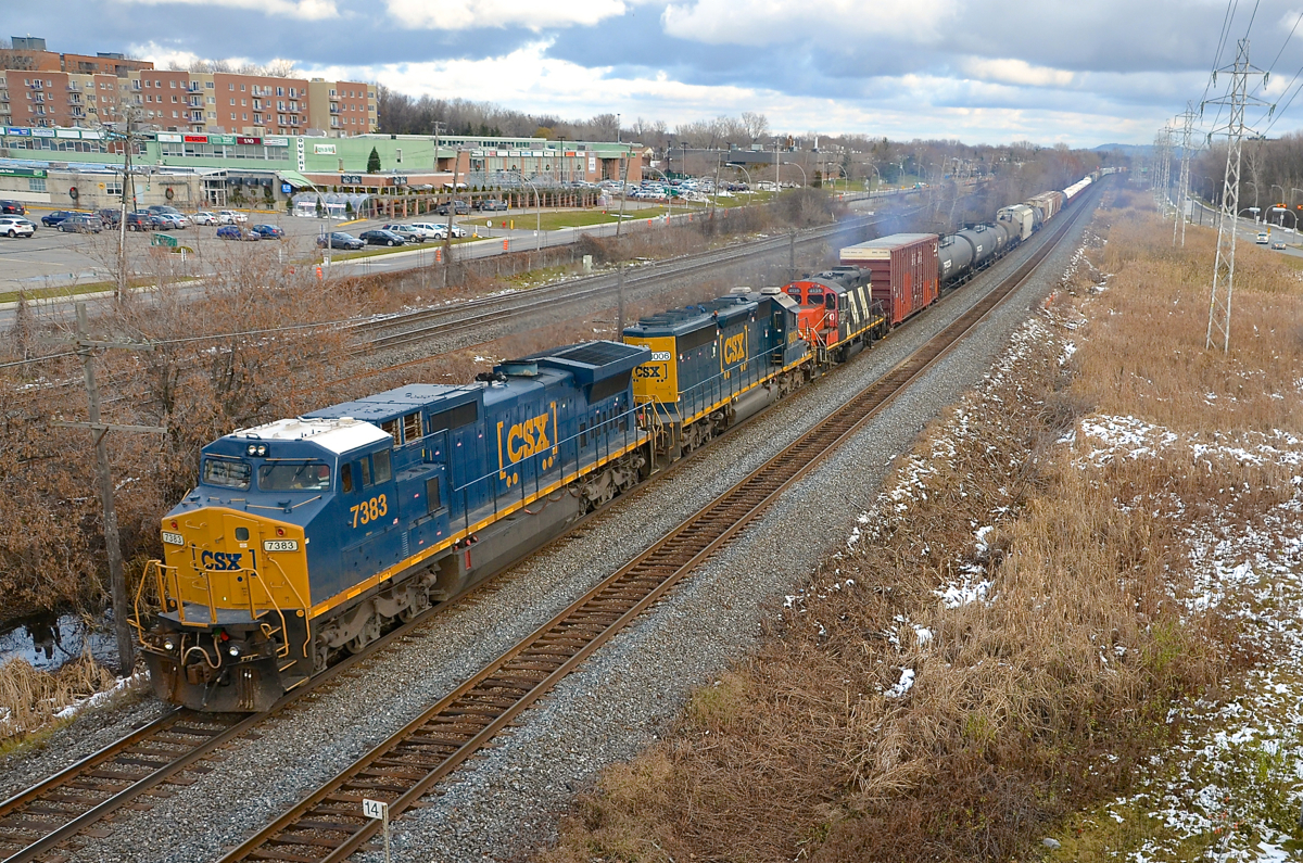 A pair of older CSXT units that have been recently repainted into the current boxcar paint scheme (ex-Conrail Dash8-40CW CSXT 7383 & ex-L&N SD40-2 CSXT 8006) are joined by even older GP9 CN 4135 (to be set off at Coteau, along with part of the train) on CN 327 which is westbound through Pointe-Claire at MP 14 of CN's Kingston Sub.