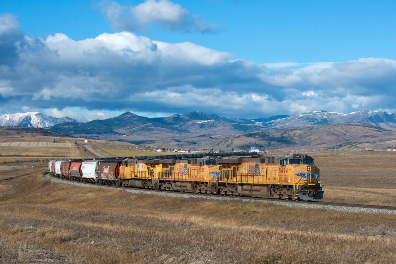 UP 5494 East has left the foothills of Crowsnest Pass behind, but still has plenty of dip's and sag's to navigate before reaching it's destination of Kipp Yard (near Lethbridge).