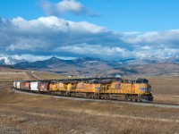 UP 5494 East has left the foothills of Crowsnest Pass behind, but still has plenty of dip's and sag's to navigate before reaching it's destination of Kipp Yard (near Lethbridge).