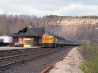 A view with a bit of everything historical. The old Dundas station, on borrowed time as steps to move it and preserve it fell thru, awaits its' demise as VIA #75 with a 'rare' MLW FPA-2u #6758 leader races by westbound. A fire, six months previous, resulted in the gaping hole in the roof was caused by an overheated oil stove that sat in the main waiting room. In front is the temporary Waiting Room for anyone who chose to board the train here. It was more vandalized than used. Behind the lead unit is VIA 6863 and another 'B', unidentified, hauling the typical long #75 of the day. Lead unit #6758 was one of only two units of this model for CN/VIA, the other being 6759. And it is the only survivor, now living as New York & Lake Erie 6758, just south of Buffalo, NY.