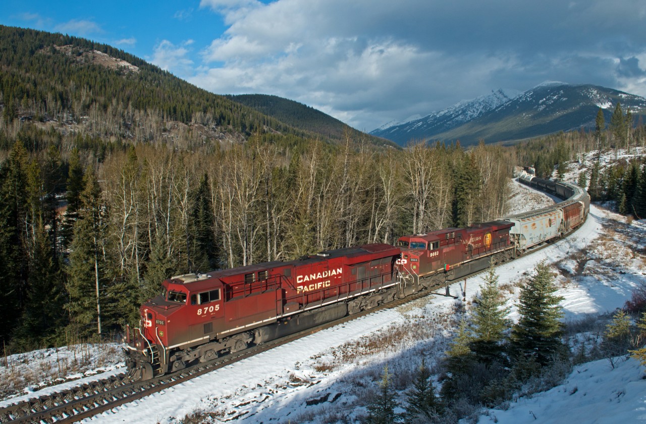 Two of CP's Finest hold back a mixed freight dropping down grade to SNS Fabro on Crowsnest Pass.