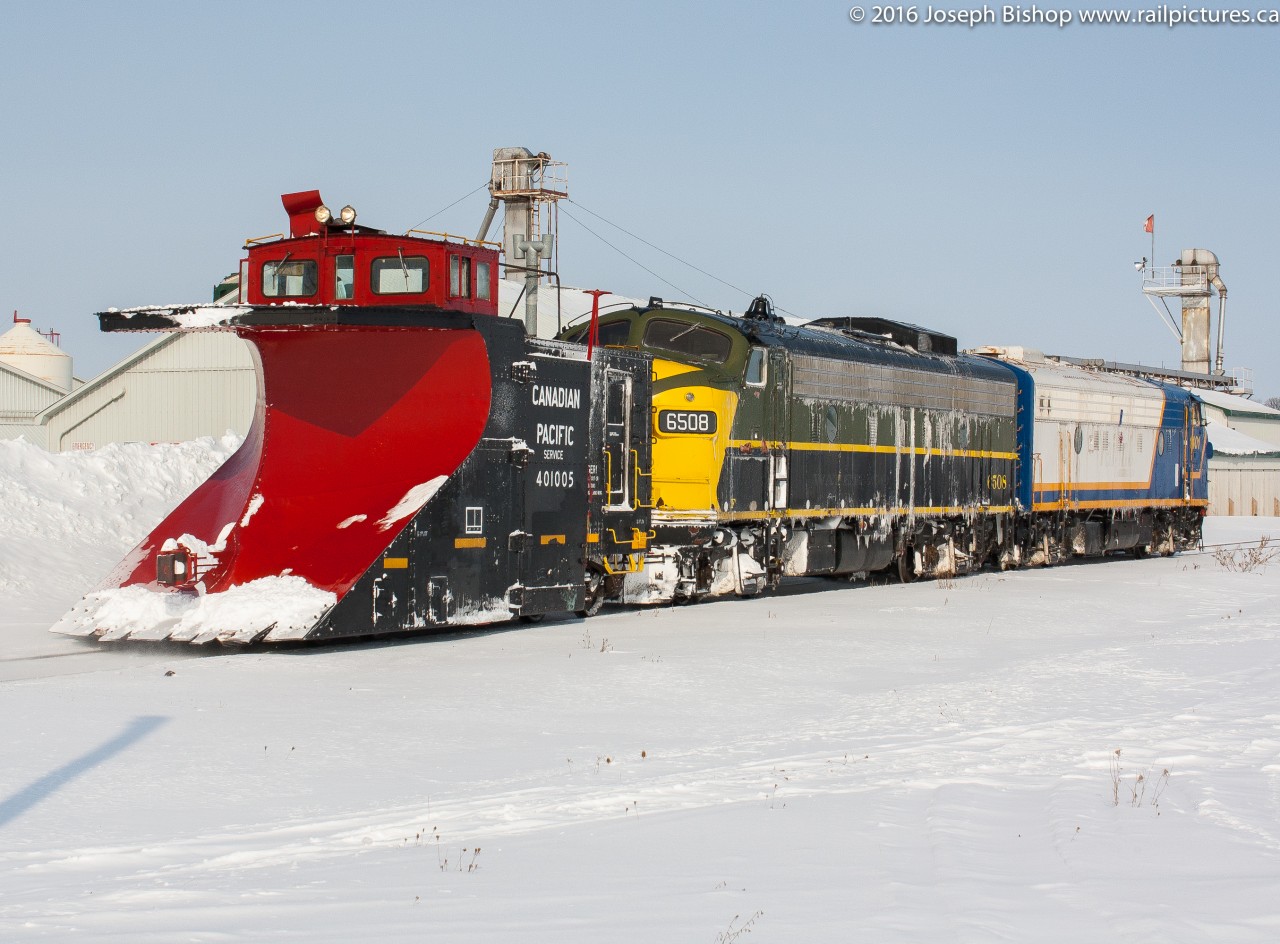 The bitter cold wind today while on yard duty reminded me of a bitterly cold day almost two years ago.  Ryan Gaynor and myself were standing in the middle of a farm field freezing our butts off waiting on the OSR plow extra to St Thomas.  Pictured here is the plow extra on its way back to Salford with OSR 1401 and OSR 6508 after putting in a long day plowing the line.  They are seen passing through Belmont.