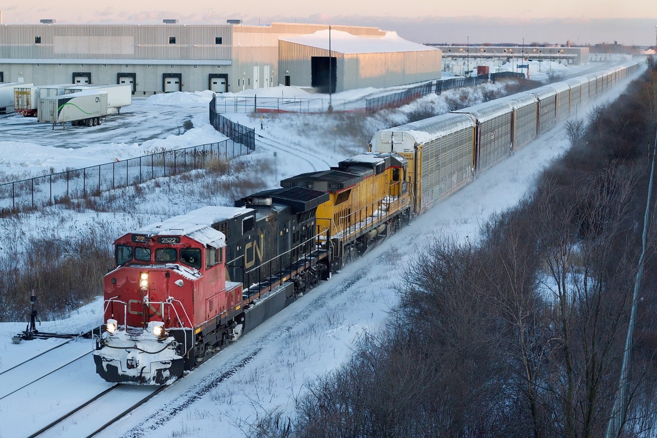 CN's first order of Dash-9s was some what unique receiving custom cabs. These were ordered just prior to privatizeation. After that point CN went more forvthe run of th mill kind of power with few road specific features. CN 2522 is showing its age with worn and weathered paint as it teams up with a former UP/CNW linage Dash-8. I kind of miss the armour yellow GE's now, with them all being repainted into CN colours. This day the train was racing Toronto bound at last light through Milton, and yes it was as cold as it looks.