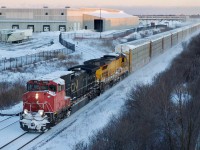 CN's first order of Dash-9s was some what unique receiving custom cabs. These were ordered just prior to privatizeation. After that point CN went more forvthe run of th mill kind of power with few road specific features. CN 2522 is showing its age with worn and weathered paint as it teams up with a former UP/CNW linage Dash-8. I kind of miss the armour yellow GE's now, with them all being repainted into CN colours. This day the train was racing Toronto bound at last light through Milton, and yes it was as cold as it looks.