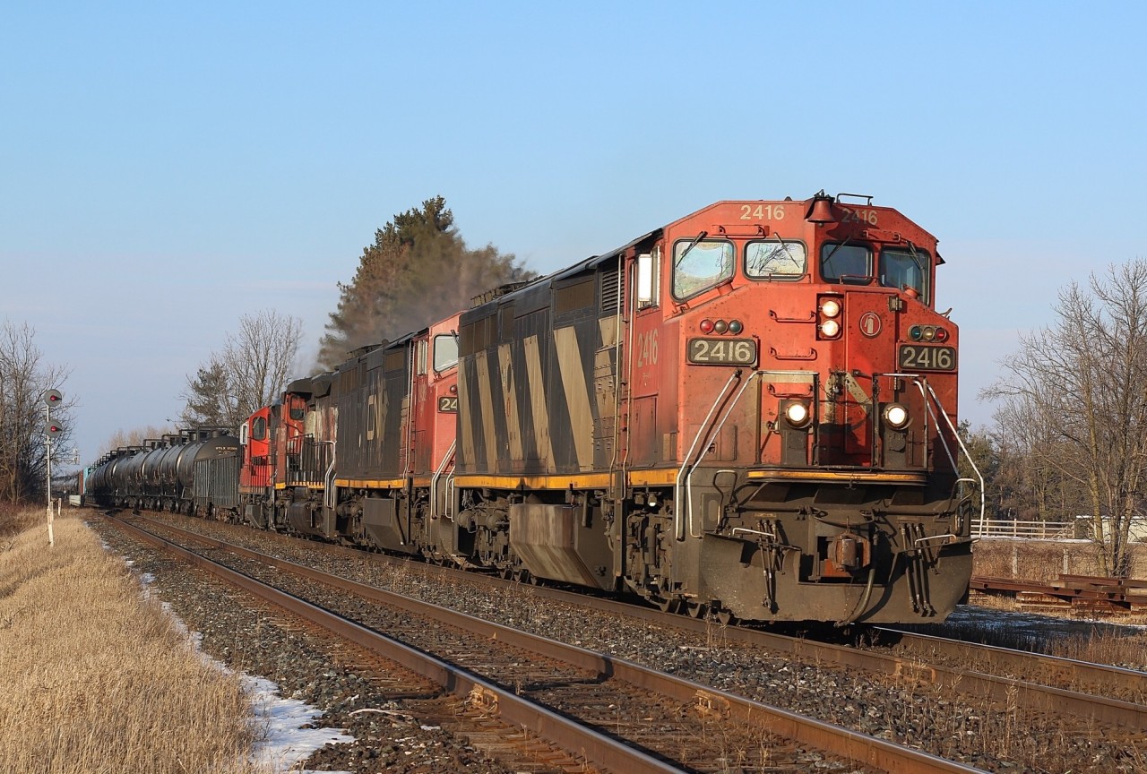 There is only as trace of snow on the ground as CN train 435 rolls back onto the double track at Steeartown after crossing over Black Creek. Today's train has some older power for its consist, which was a nice change from the endless parade of newer GE and EMD units typically on most trains in the area these days. Up front is a pair of cowl Dash-8s, followed by a SD40 and a GP9 in transit to London.