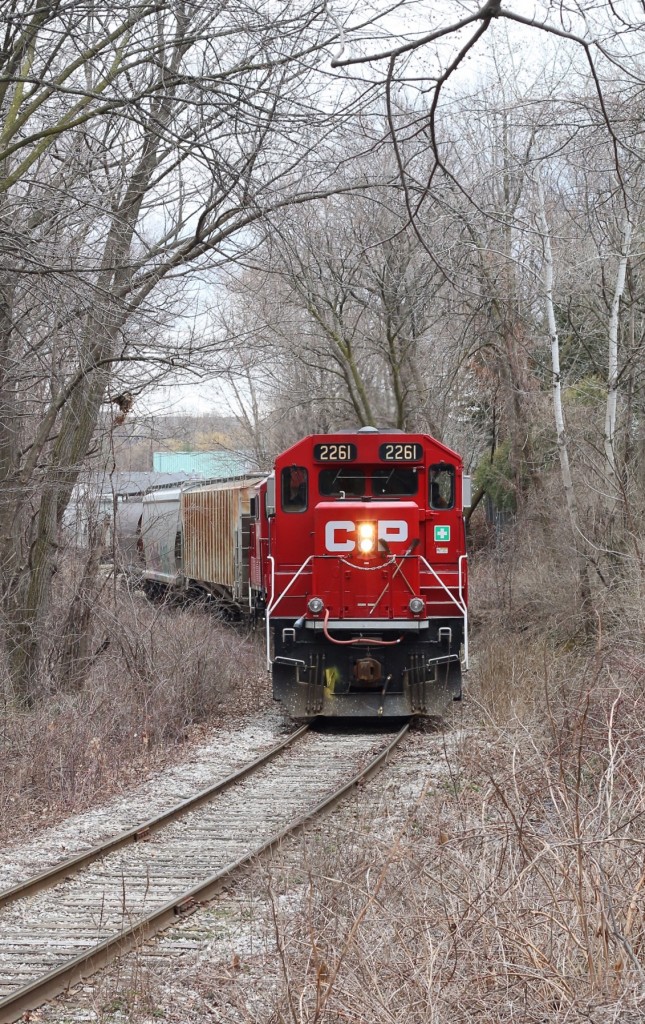 CP T14 has three covered hoppers in tow as the train heads back to the mainline to swap the cars for three other covered hoppers. The short tree lined spur connects the mainline to the old ADM elevator, and for a brief period while the Credit Valley Railroad (now Canadian Pacific) was being planned, the original intention was to have the CVR mainline run along side the Credit River near the spurs location and run down to a connection with the Great Western Railroad at Port Credit. This idea was quickly disposed of and the mainline soon continued on to York (now Toronto). It's hard to believe that after so many decades of continual service, that today, half a year after this photo was taken, that now the facility has been sold and the new owner Cargil currently receives no rail service.