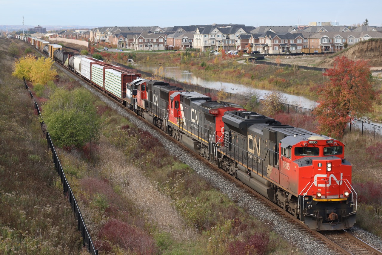 CN train 399 passes through new Milton suburbs only a few hours ahead of numerous "trick or Treaters"taking to the streets. Tucked in behind the CN power is GMTX 724, a former IHB SW900.
