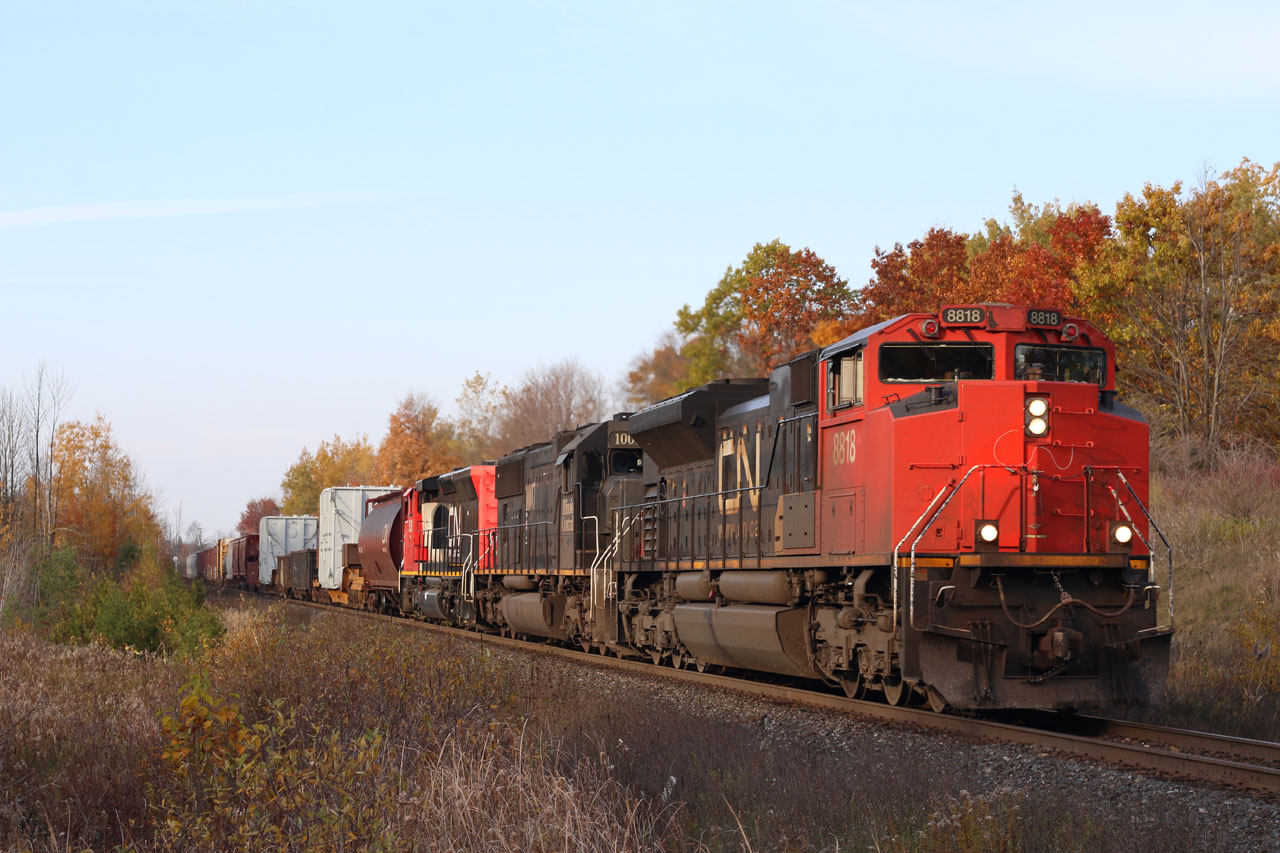 CN train 399 rolls past the fading fall colours at Scotch Block. In the consist is nose logo less SD70M-2 8818, IC SD70 1007 and natural gas fuelled SD40-2W 5258. A pair of dimensional loads are also visible trailing the power.