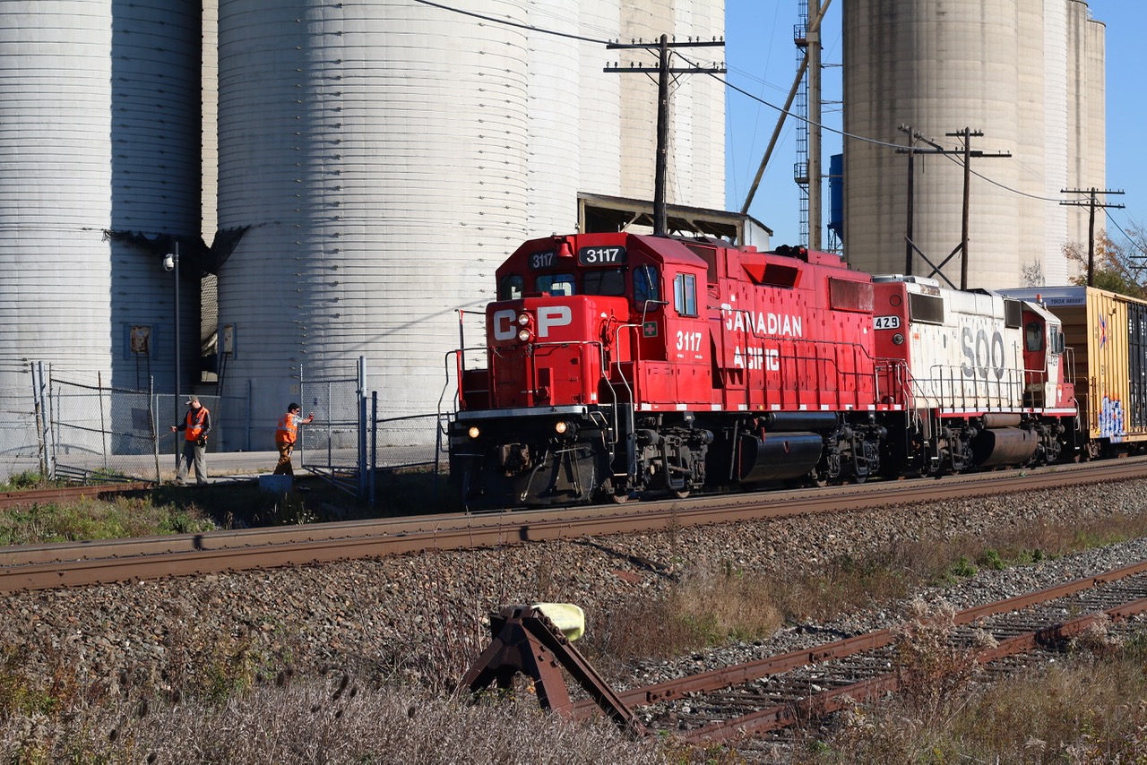 While it certainly doesn't happen as often today as it once did, the one time Reid's Mill, now Ardent Mill still receives cars from time to time. SOO Line GP38 429 in the consist this day was a bonus. Here we see the crew opening the gates so that four covered hoppers can be dropped off inside the facility. The currently unused ADM spur is in the foreground.