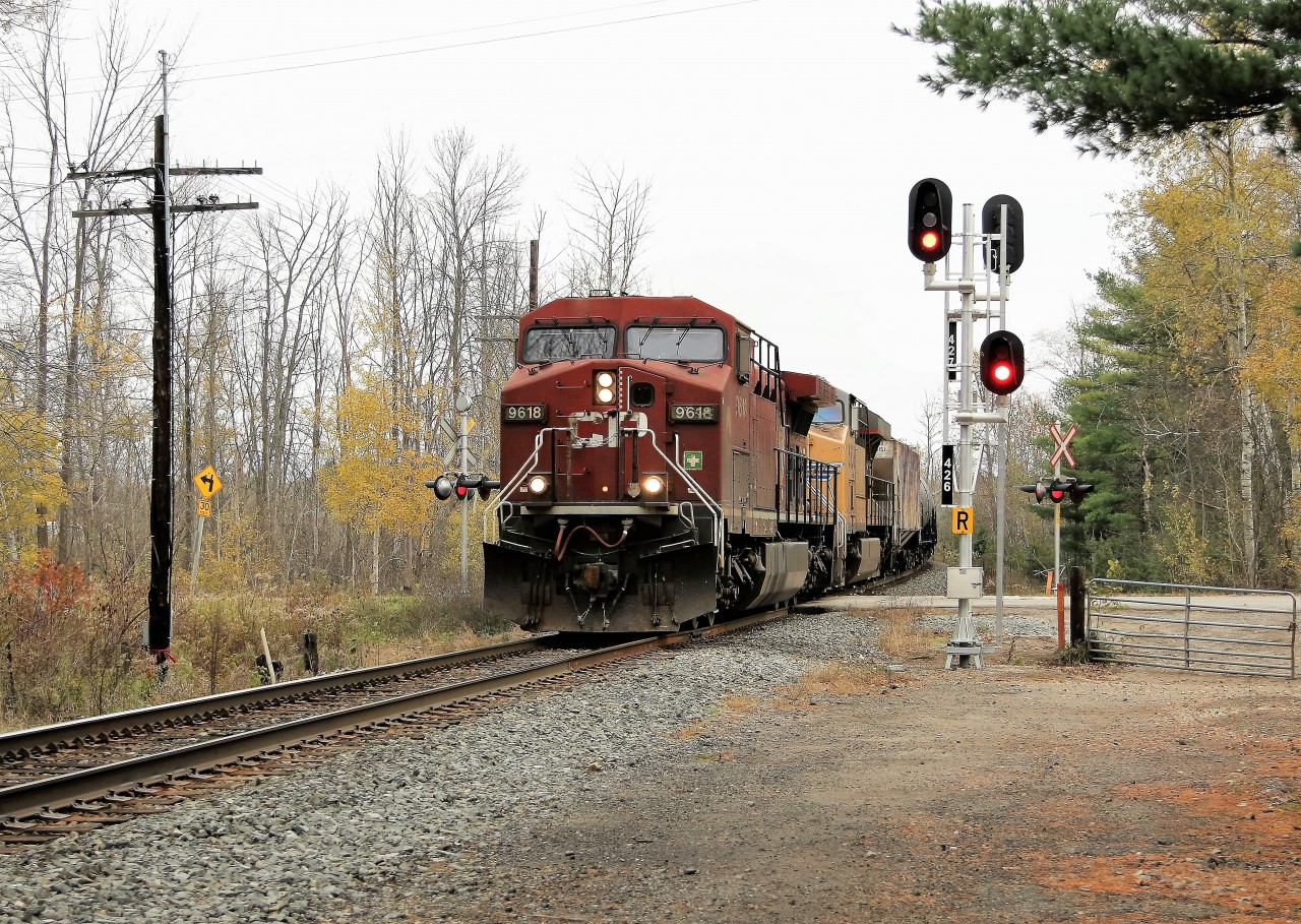 The end of the searchlight signal era is upon us. The new ABS signals are illuminated for CP 651 with CP 9618 leading UP 5538 across the 14th Concession, headed west cleared to Orr's Lake with its manifest of empty ethanol cars.