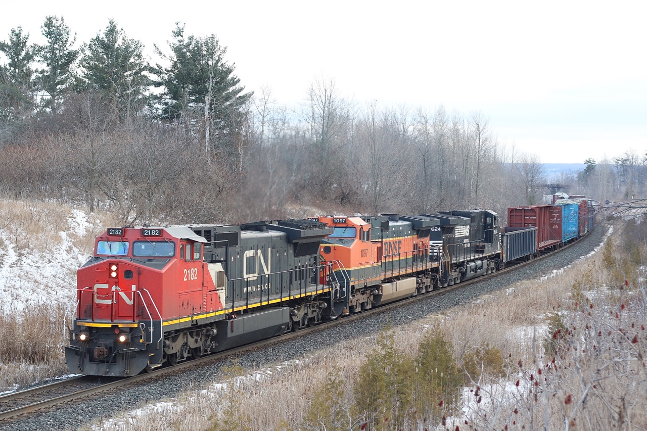 The grey winter days are not far off now. Here we have one of CN's former BNSF Dash-8s leading a BNSF and NS Dash-9 up the slight grade at Scotch Block. This photo shows how similar the two engine models are externally, with the trucks being the main spotting feature. The "gull wing" cab roof contour was a ATSF/BNSF special order, which allowed the units to fit through on line coal loaders.