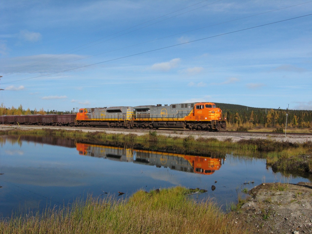 An almost picture perfect reflection of a typical QNS&L ore train about to cross Highway 500, the Trans Labrador Highway, on a crisp early October morning. Having just left Labrador City, lead unit AC4400 # 422 and SD70 # 502 will travel some 260 miles to the Port of Sept-Iles. The trains may be gone forever on the Island portion of our Province, but fortunately such is not the case in Labrador, and in fact, may never be.