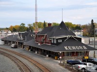 It is great that the Kenora CP station complex has been designated 'Heritage',(1991) as it is a beautiful sight. This view was taken from the Matheson St overpass at the west end of the yard. Kenora station was constructed back in 1899. The left foreground, a parking area for staffers and employees, was once a beautiful garden, complete with lush grasses and endless flowers. The idea was for new Canadians heading west to start a new life would see the beauty at station stops and give them encouragement for what lied ahead. Boy were they in for a surprise!!! There was no beauty in landing somewhere in Saskatchewan or Southern Alberta and fending oneself against a prairie winter. Many newbies stuck it out though, and as the years passed the railroads, as the major highways in the east, cut back on "beauty" as a non-contributor to the bottom line and neglect took over.