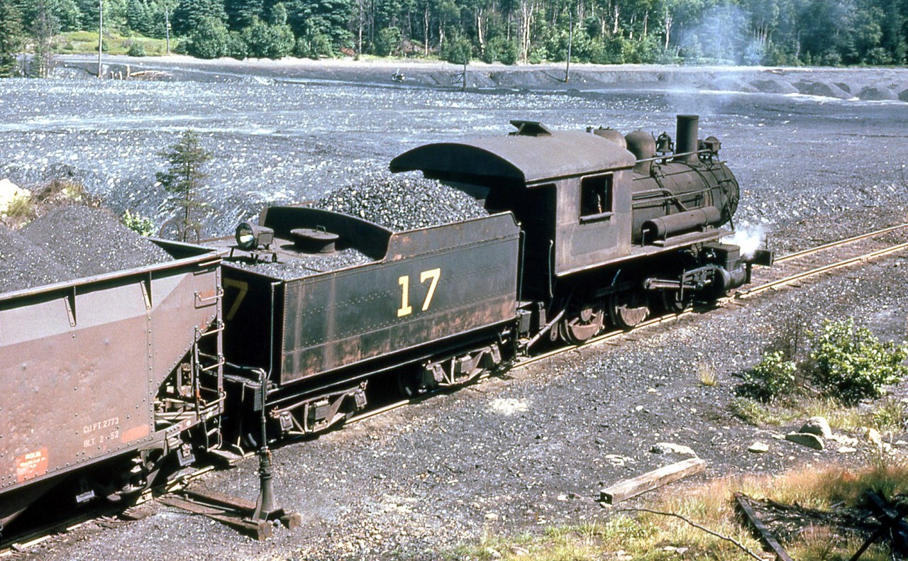 Old Sydney Collieries 2-6-0 17 is shown shuffling coal cars in August 1961. It was originally built by Alco of Schenectady NY in 1903 as Nova Scotia Steel & Coal 2-6-4T 10 (later rebuilt as a 2-6-0). It became Old Sydney Collieries 17, working out of Sydney Mines NS, and worked for two other coal operations before ending up on static display at Glace Bay NS. Unfortunately, research indicates it's since been scrapped.

(Original photographer George Schaller, duplicate slide from the collection of Bill Thomson and posted on behalf of and with Mr. Schaller's full participation).